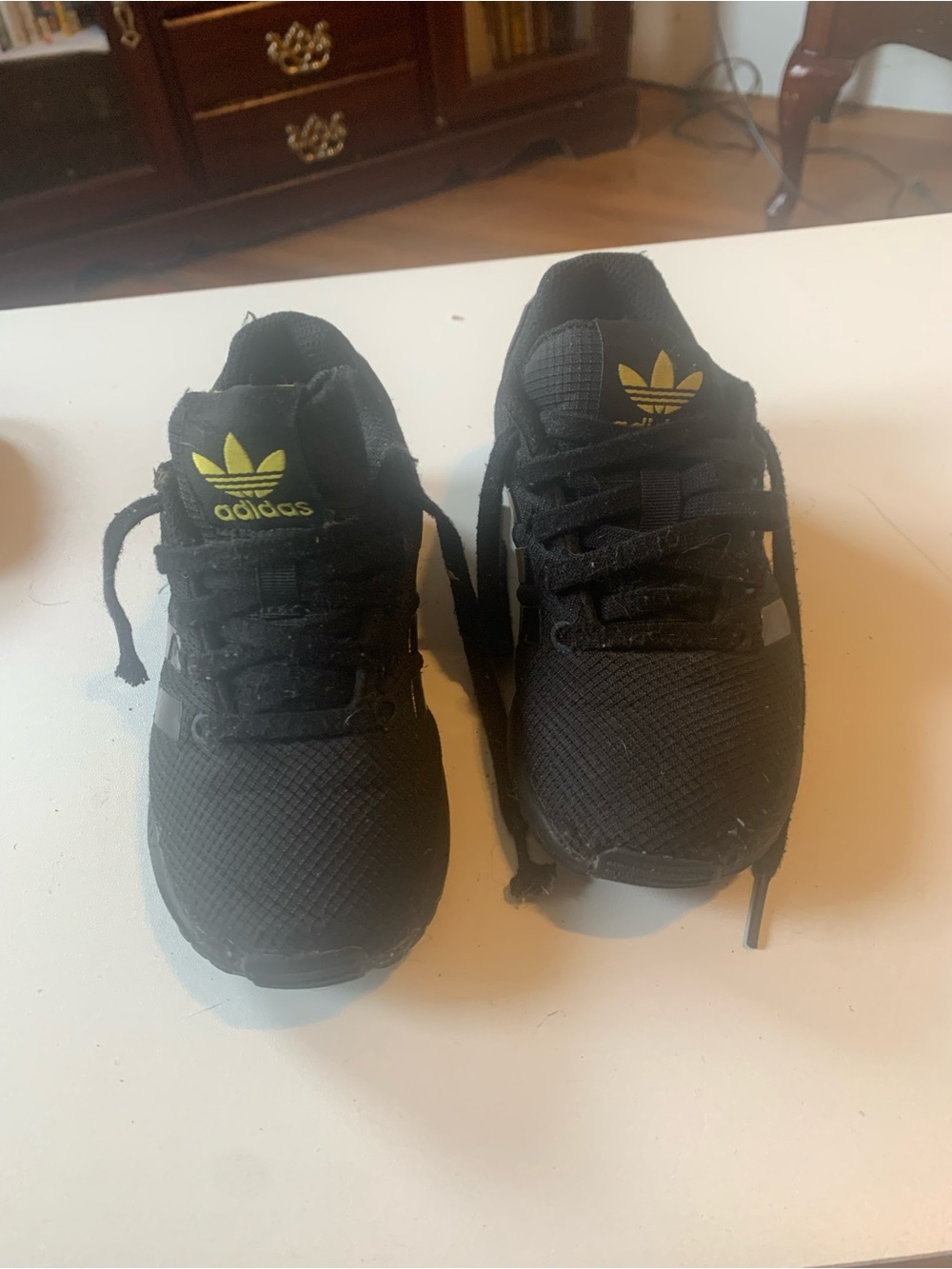 adidas Black Trainers with Yellow Trefoil Accents